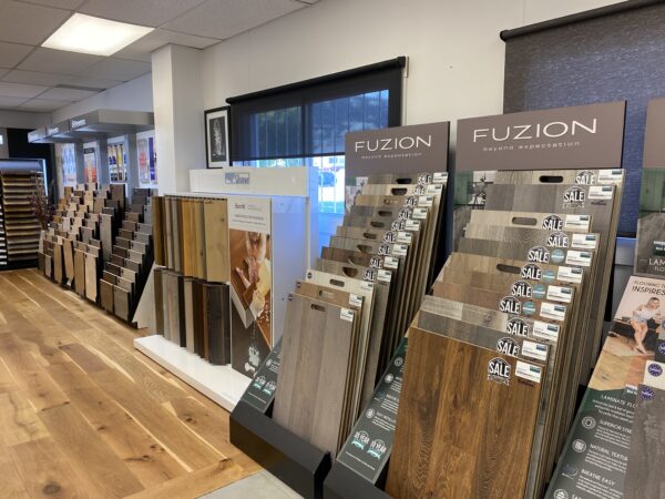 Hardwood flooring samples from Preverco, Shaw Floors and Fuzion flooring, displayed along the wall at the Nufloors Kamloops store