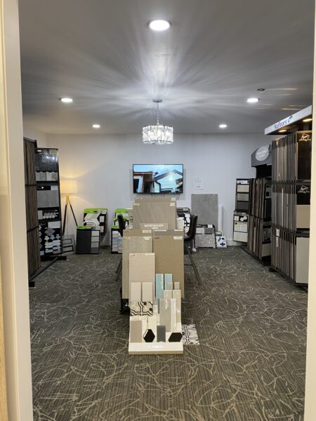 Looking into the tile room at Nufloors Kamloops, with samples from various tile brands lining the walls and in a centre display