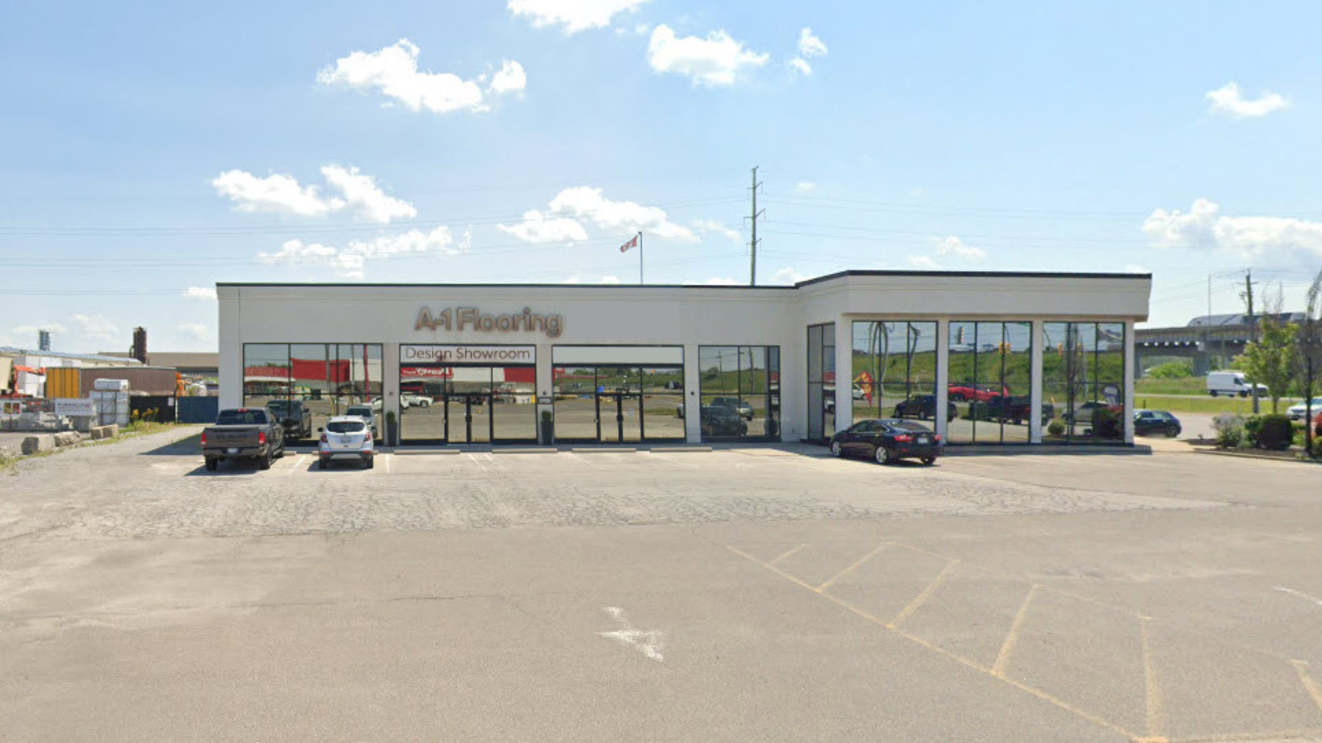 A1 Flooring St. Catharines flooring store exterior, showing the parking lot with cars parked outside and the building against a blue sky