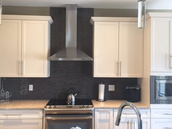 Kitchen with dark brown wall tiles.
