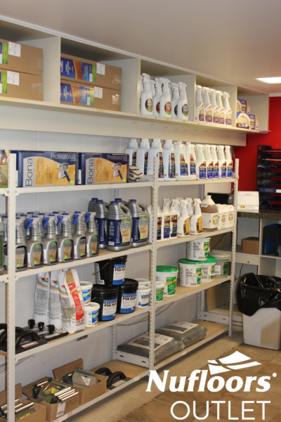 Floor cleaning and installing products on a shelf in a Nufloors Outlet.