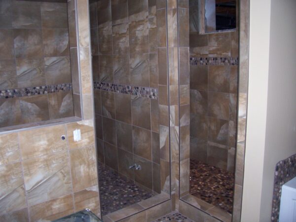 Wooden textured tiles on walls and small tiles on the floor.