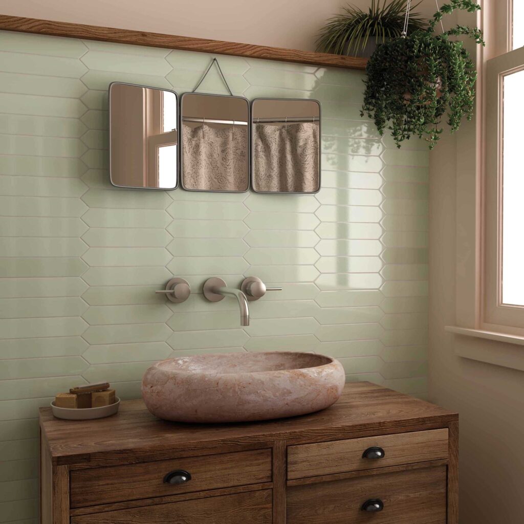 light green subway tile in a natural bathroom with a stone sink and wooden vanity