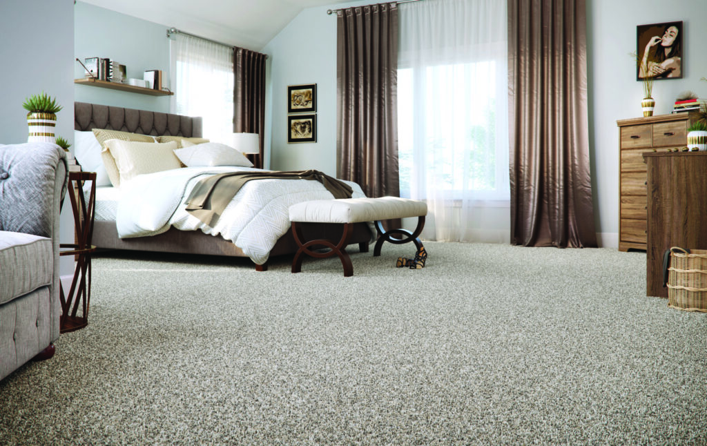 Bedroom with decor in different shades of brown and Nature's Elegance SmartStrand carpet by Mohawk, highlighting how fall weather can impact carpet