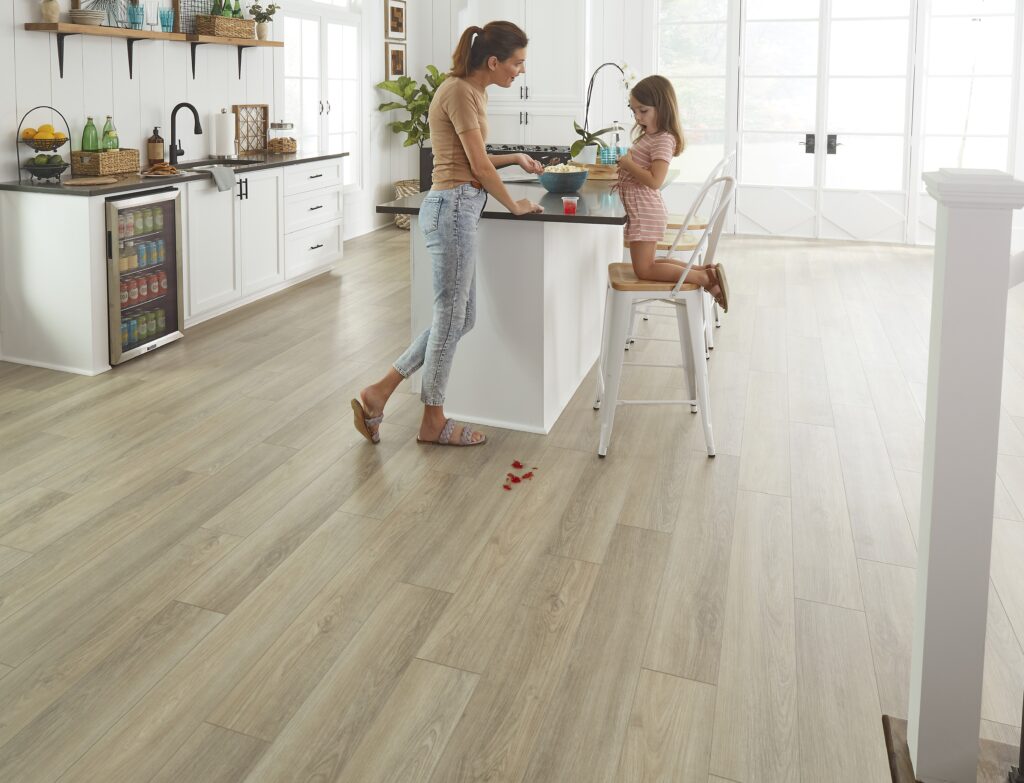 luxury vinyl flooring by mohawk flooring, pictured here in a modern farmhouse style kitchen with a mother and daughter next to the kitchen island