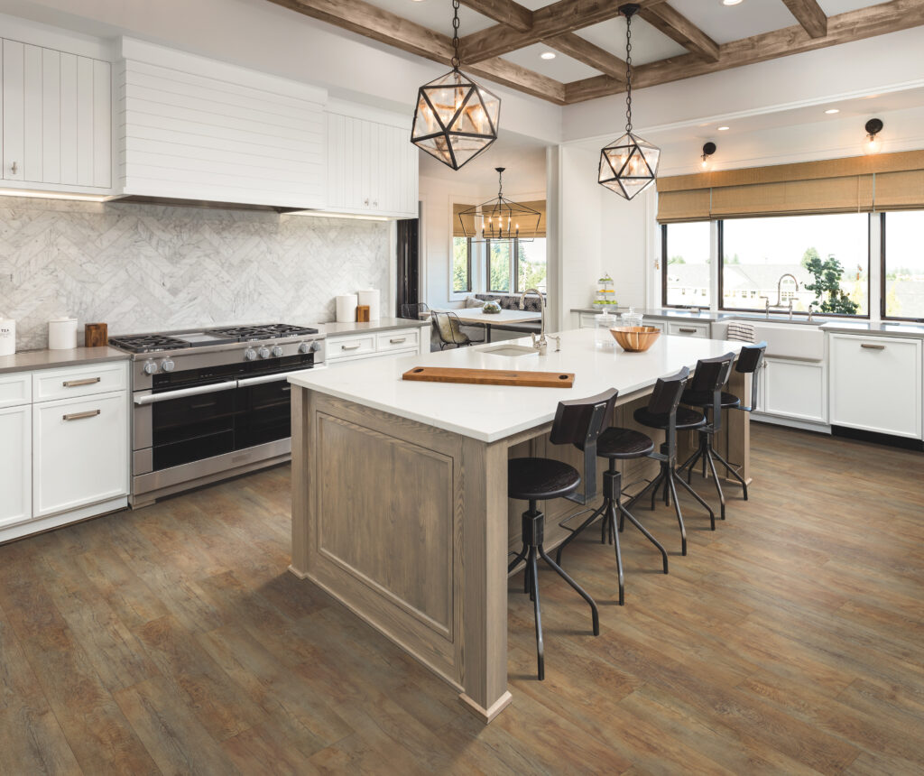 a modern farmhouse style kitchen with wood accents, white cabinets, and luxury vinyl flooring that looks like hardwood