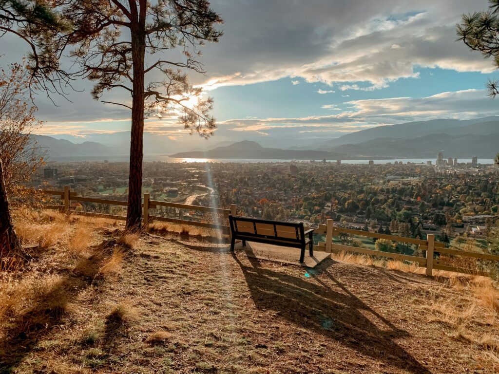 the city of Kelowna from a viewpoint overlooking the city, lake and mountains.