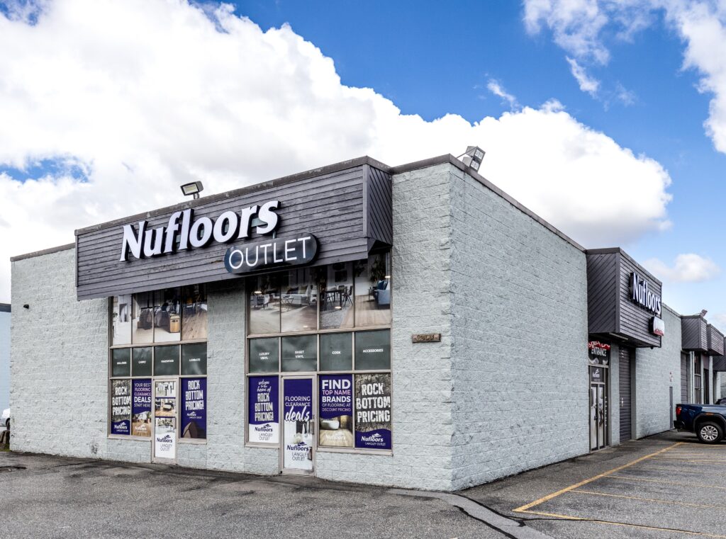 the Nufloors Langley outlet store exterior with a large branded sign against a grey brick building