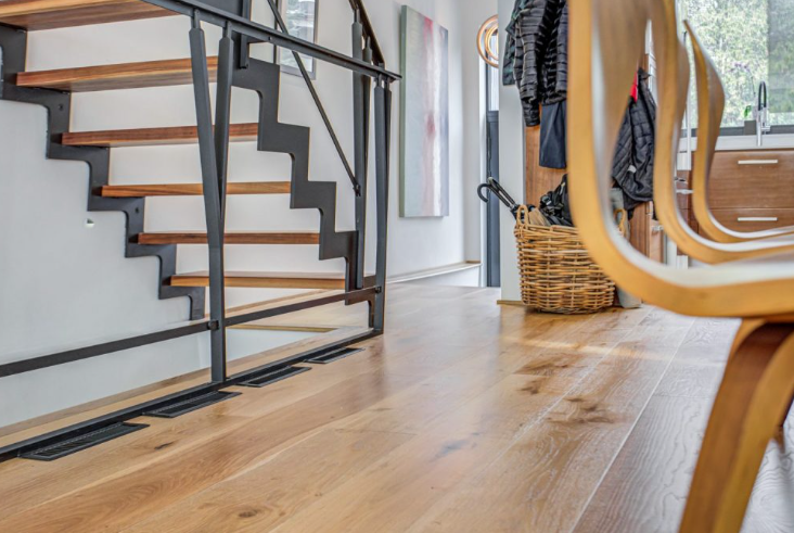 a close up of hardwood flooring in an entryway of a home