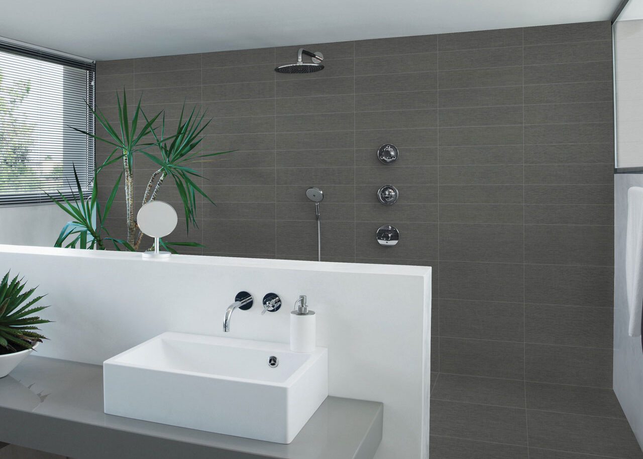 Ames Tile & Stone featured in a bathroom, in collection Belgian Weave, a dark grey shower tile