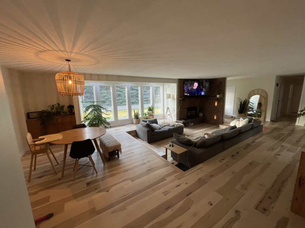 a sunken floor living room by Nufloors Saskatoon, using Planchers Mercier Wood Flooring in colour Hickory