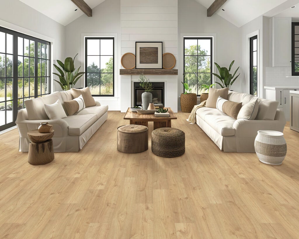 A living room with two comfortable couches, side tables, and using Mohawk RevWood sustainable and eco-friendly flooring.