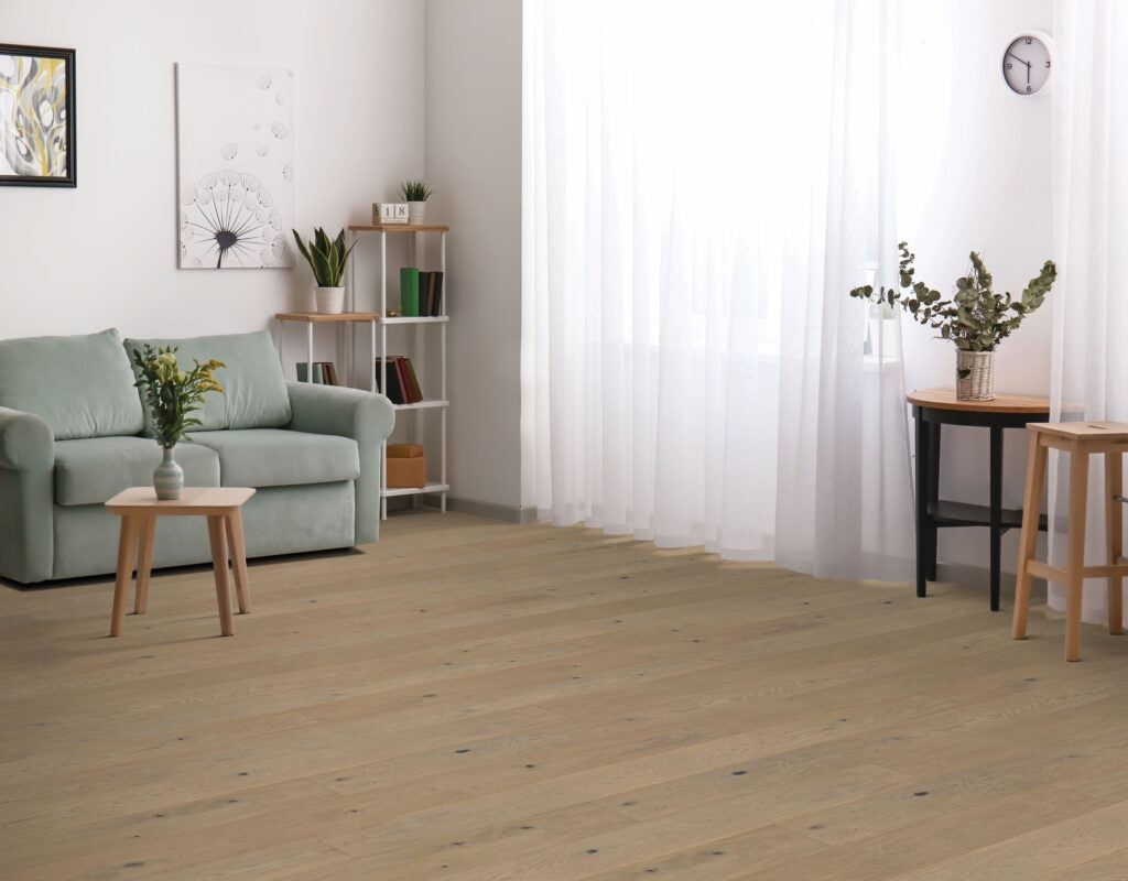 A picture of a living room with Beaulieu engineered hardwood flooring from their from Maestro collection.