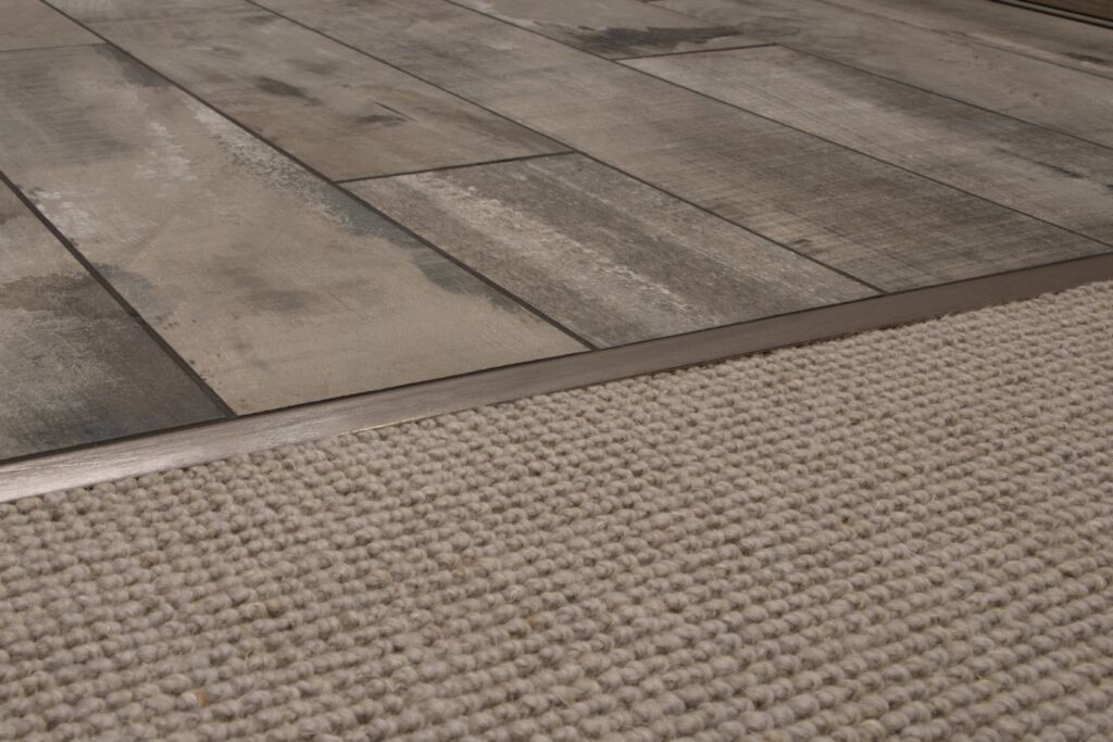 Transition strip between laminate flooring and carpet.