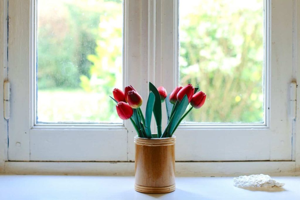 Fresh flowers by the window sill