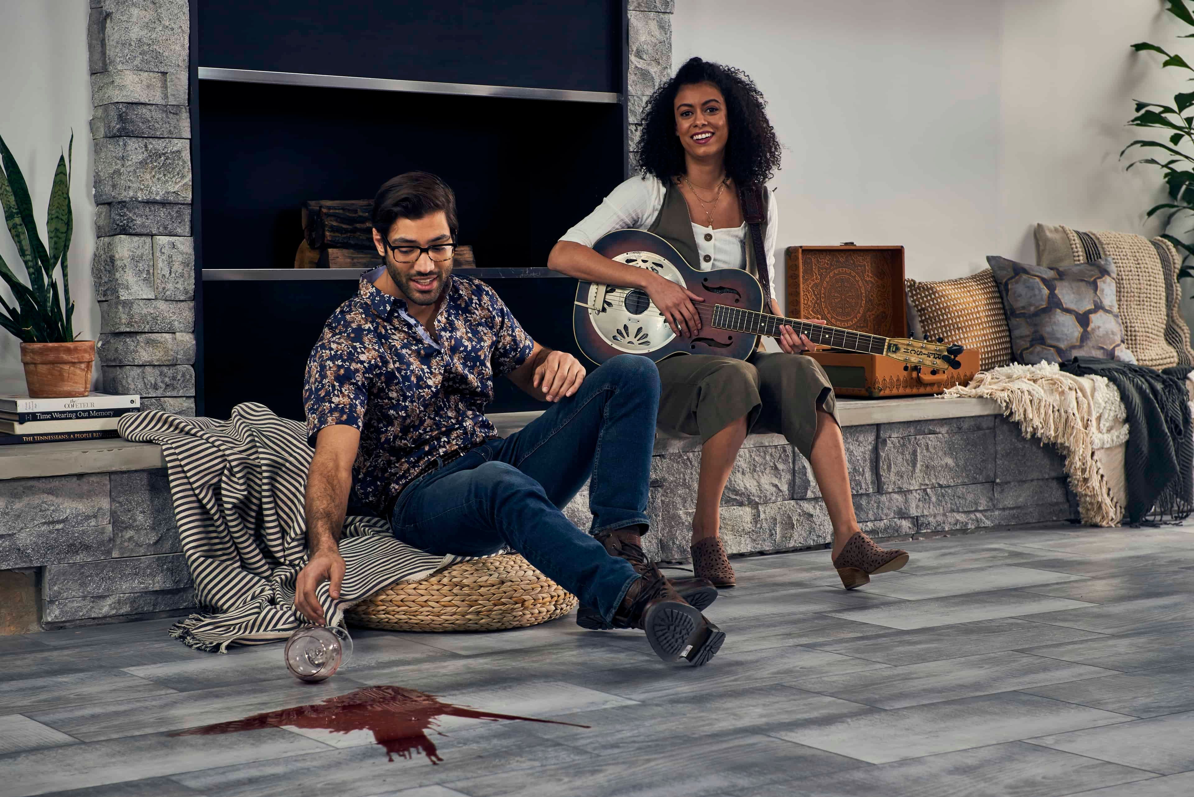 Man spilling wine on floor during gathering.