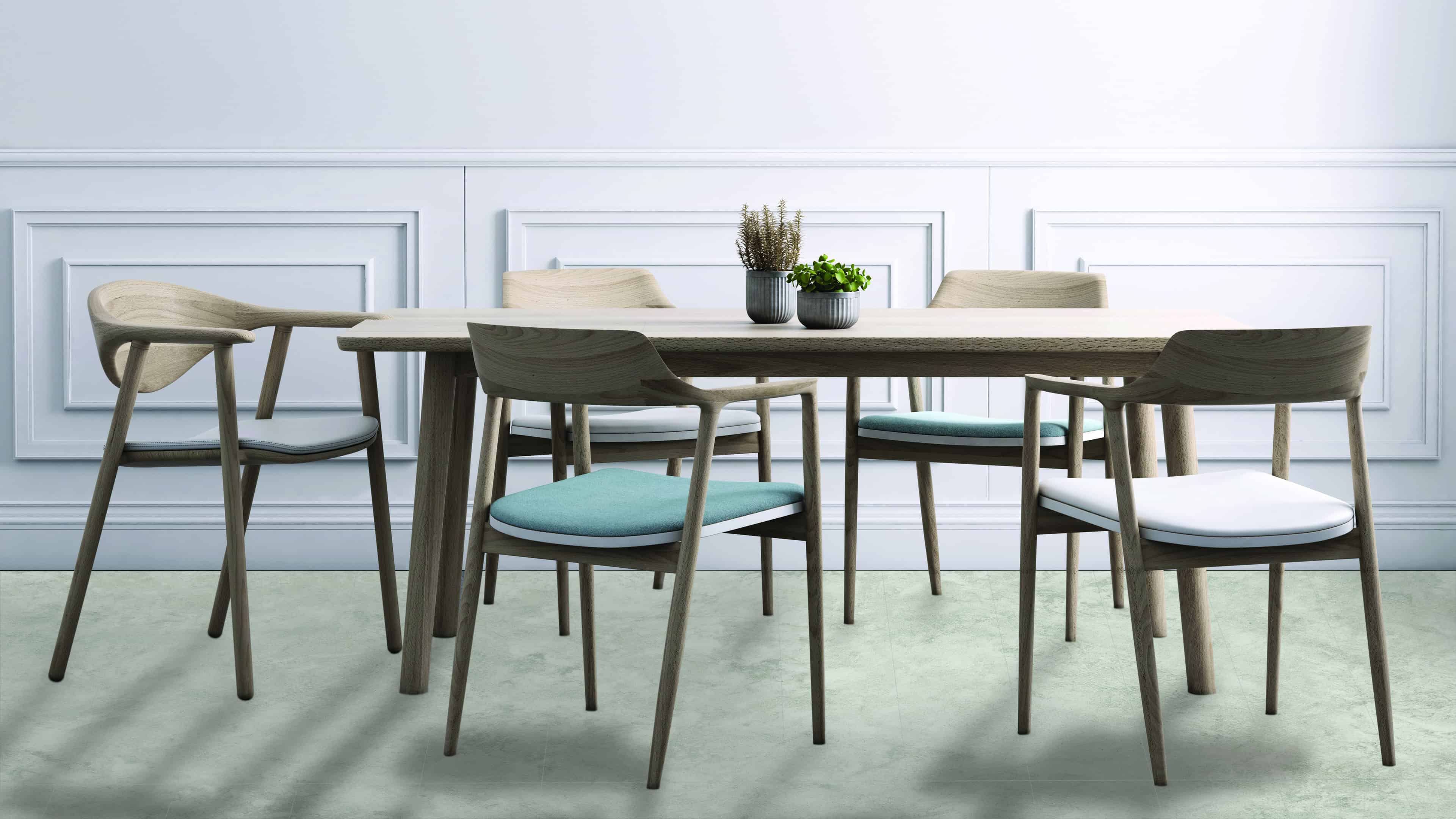 Dining room apartment interior with wooden chairs and table, green plants on table.