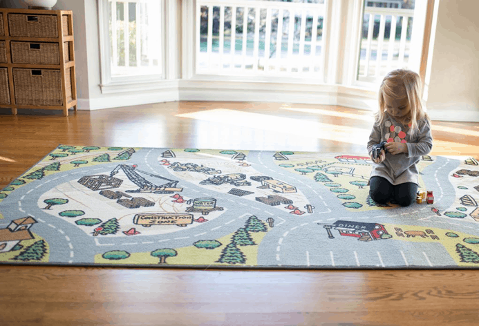 High-traffic? Literally. Toddler playing on cartoon city rug. Some of the best rugs for high-traffic areas include play spaces.