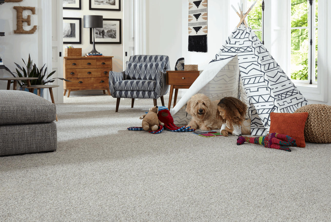 Child and dog in tent playing on carpeted floor