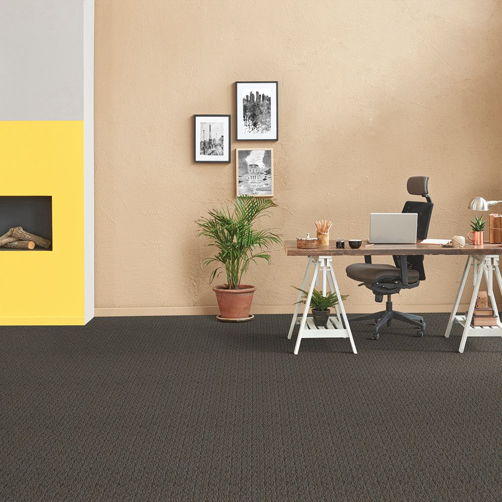 Cypher carpet by Beaulieu Canada, featured in a peach and yellow home office with a standalone desk, swivel chair and potted plants.