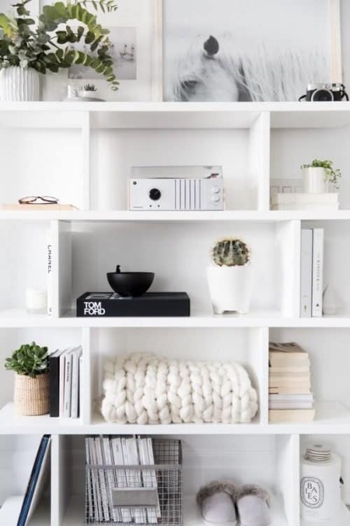 White decorated shelves with various decor items.