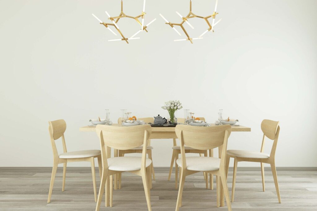 Light and bright dinning room with scadi style table and chair set and light fixture.