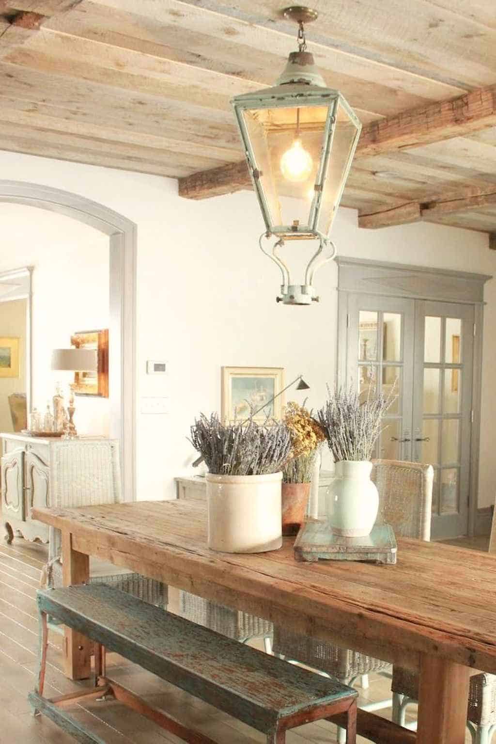 French country dining room decor on reclaimed wood table.