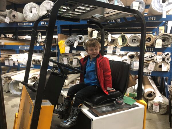 A kid on a forklift.