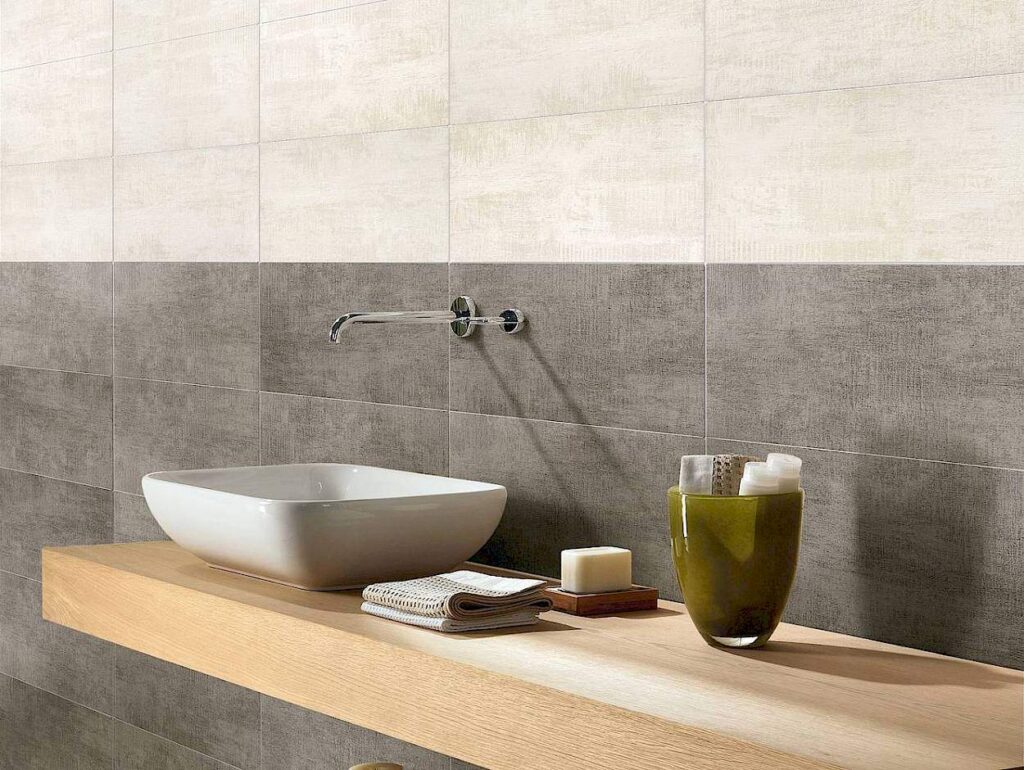 Grey and Cream coloured wall tiles in a bathroom.