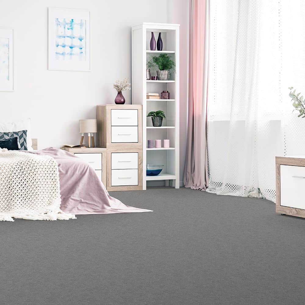 White room with pink decor accents and grey carpet; highlighting how you can increase home value with new flooring.