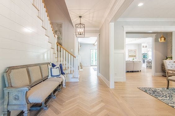 Light coloured hardwood in entryway in herringbone pattern