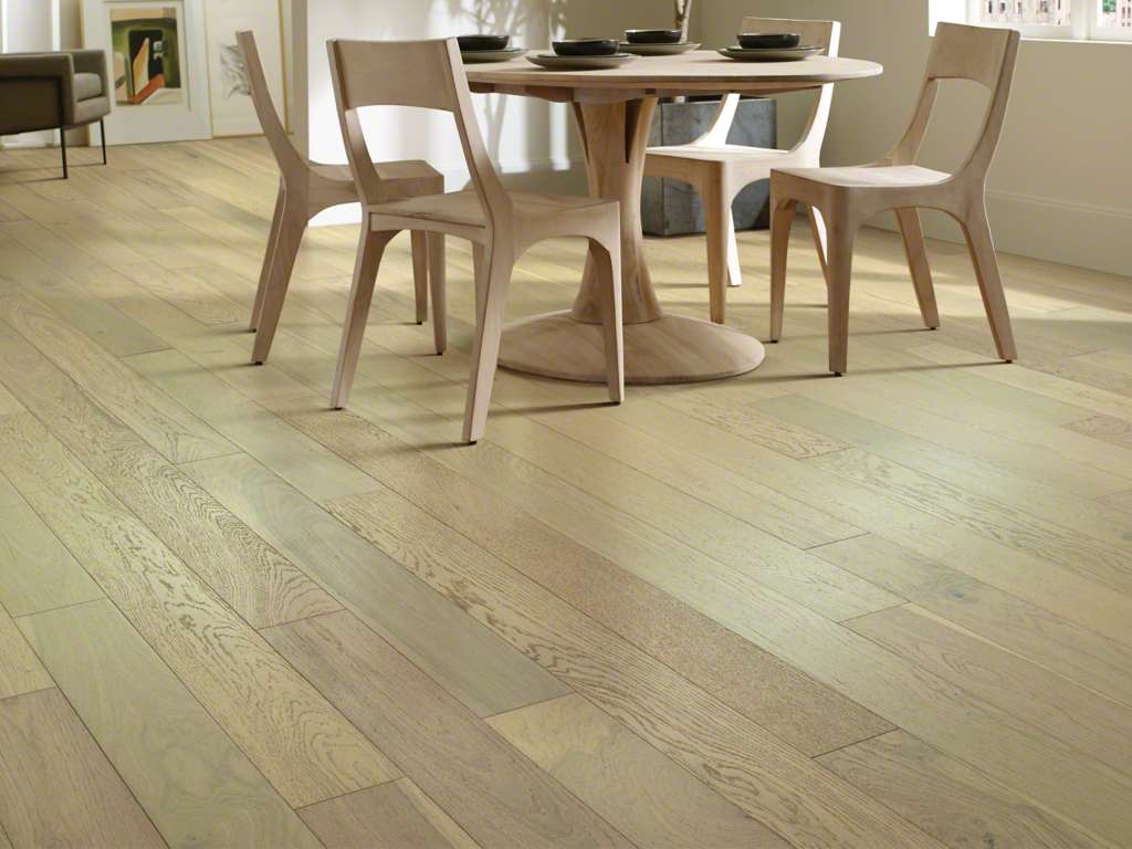 Light hardwood floors in dining room.