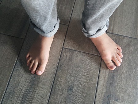 Closeup of feet on infloor heated flooring