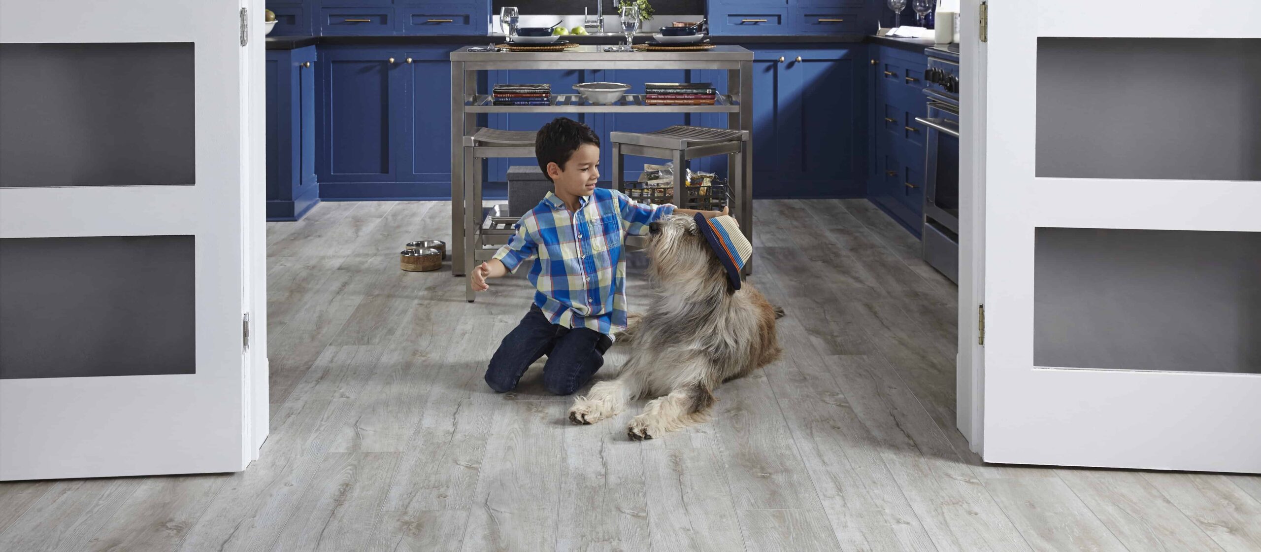 Kid and Dog playing in kitchen on Aspen Frost Flooring