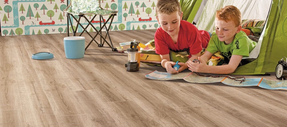 Laminate is another of the four types of family friendly flooring. Kids playing in tent on laminate flooring
