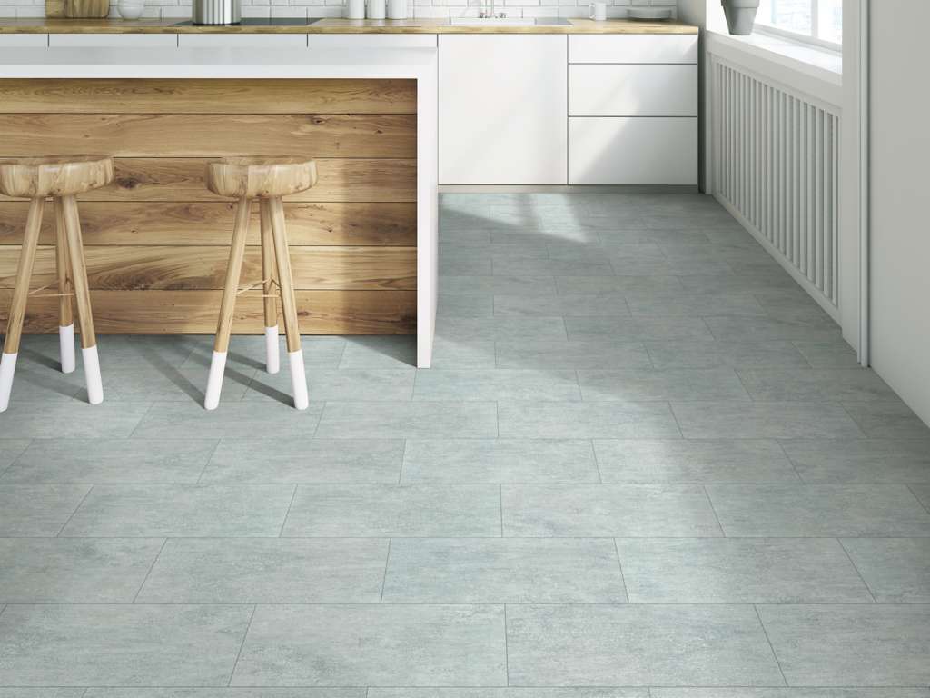 Kitchen with wooden underside of island and grey tile floors.