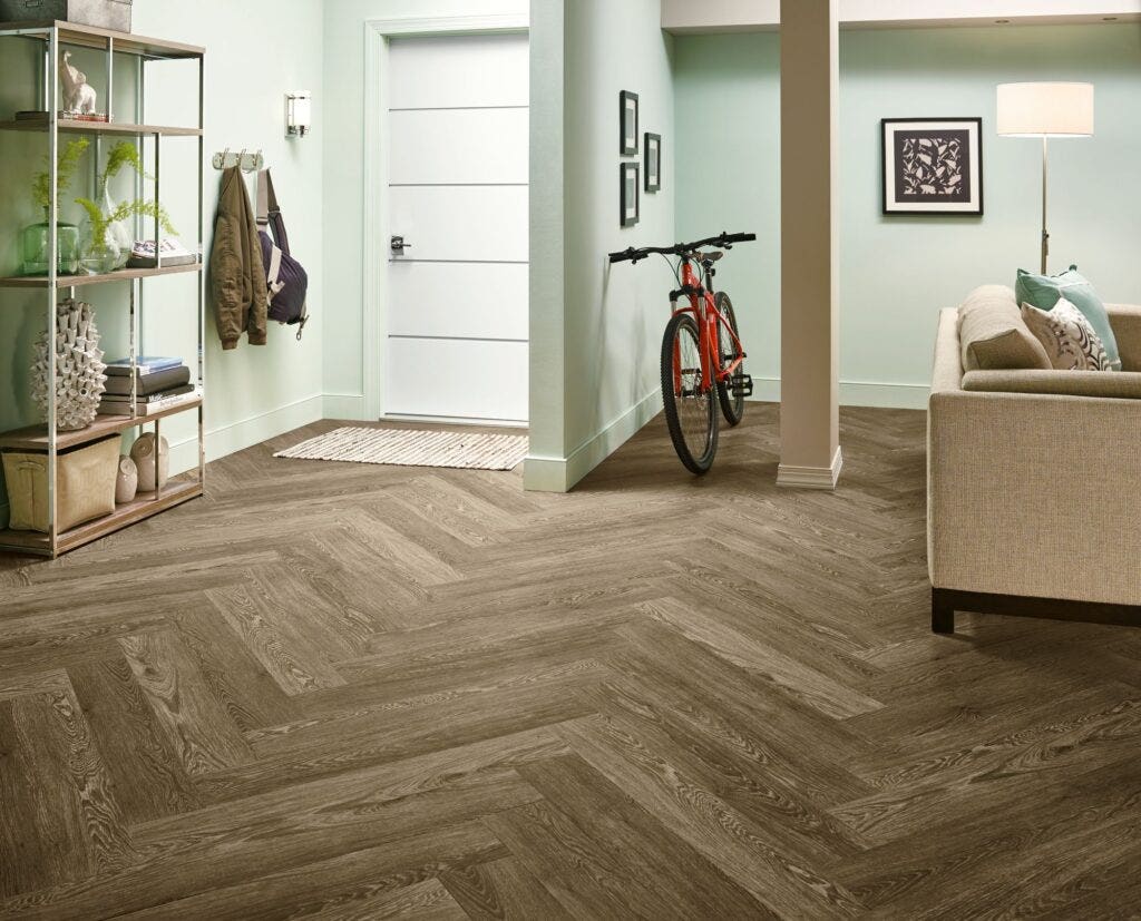 Living room and entryway in a basement suite with luxury vinyl flooring.