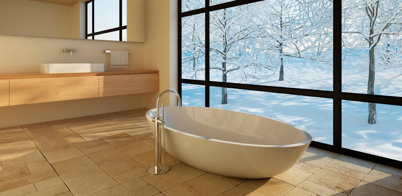 Modern bathroom soaker tub with winter outside the window