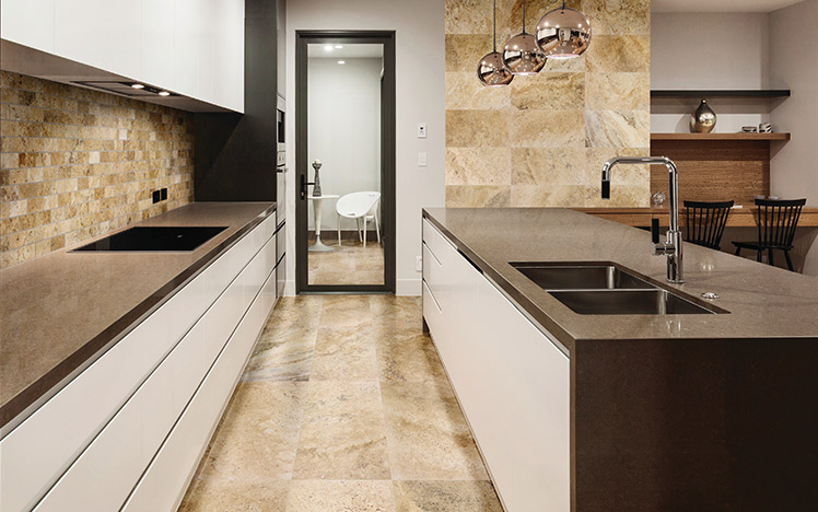 Light brown natural stone tiles in a kitchen on the floors and walls