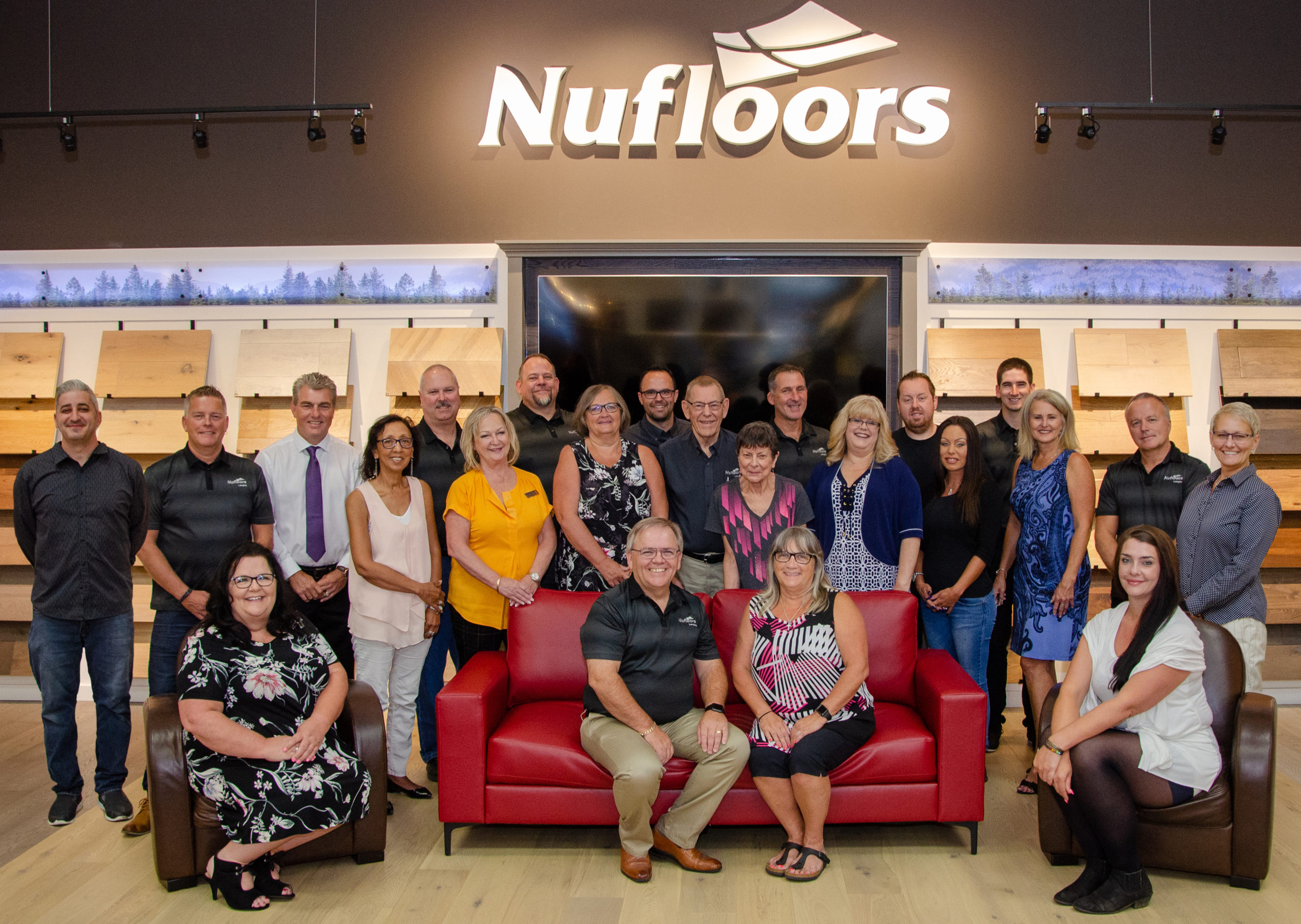 Staff members of Nufloors Langley sitting and standing.