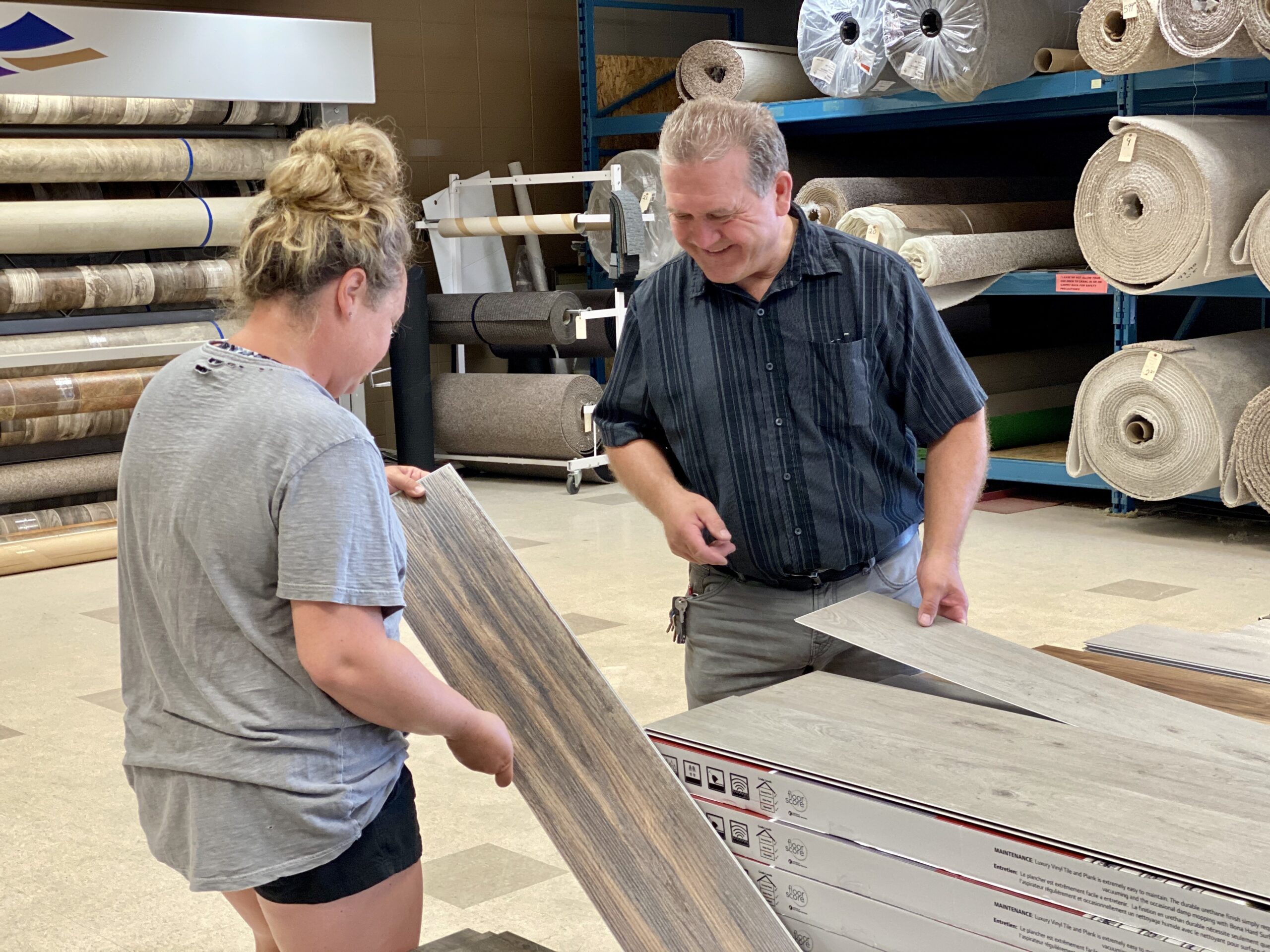Nufloors Slave Lake associate helping Customer with laminate flooring