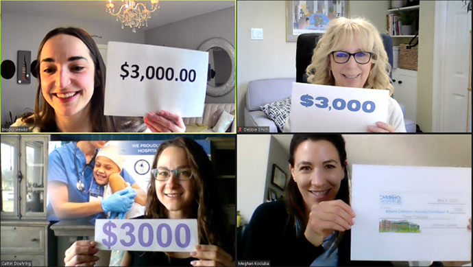 Four women showing dollar amounts for the Red Deer Donation for Children's Hospital.