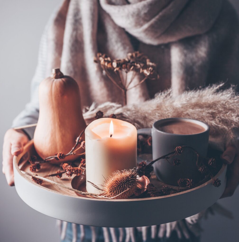 Fall decor including squash, candles, and hot cocoa