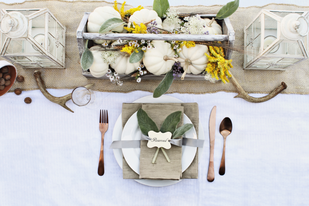 Fall table setting with white pumpkins.