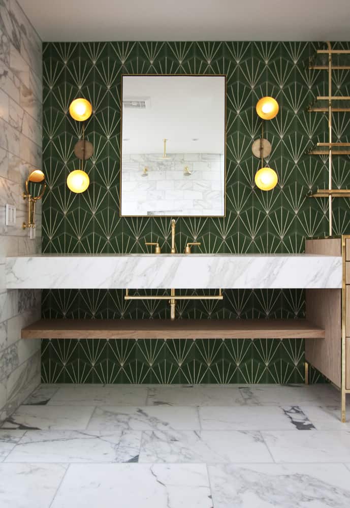 Washroom with green wall tiles and marble floor.