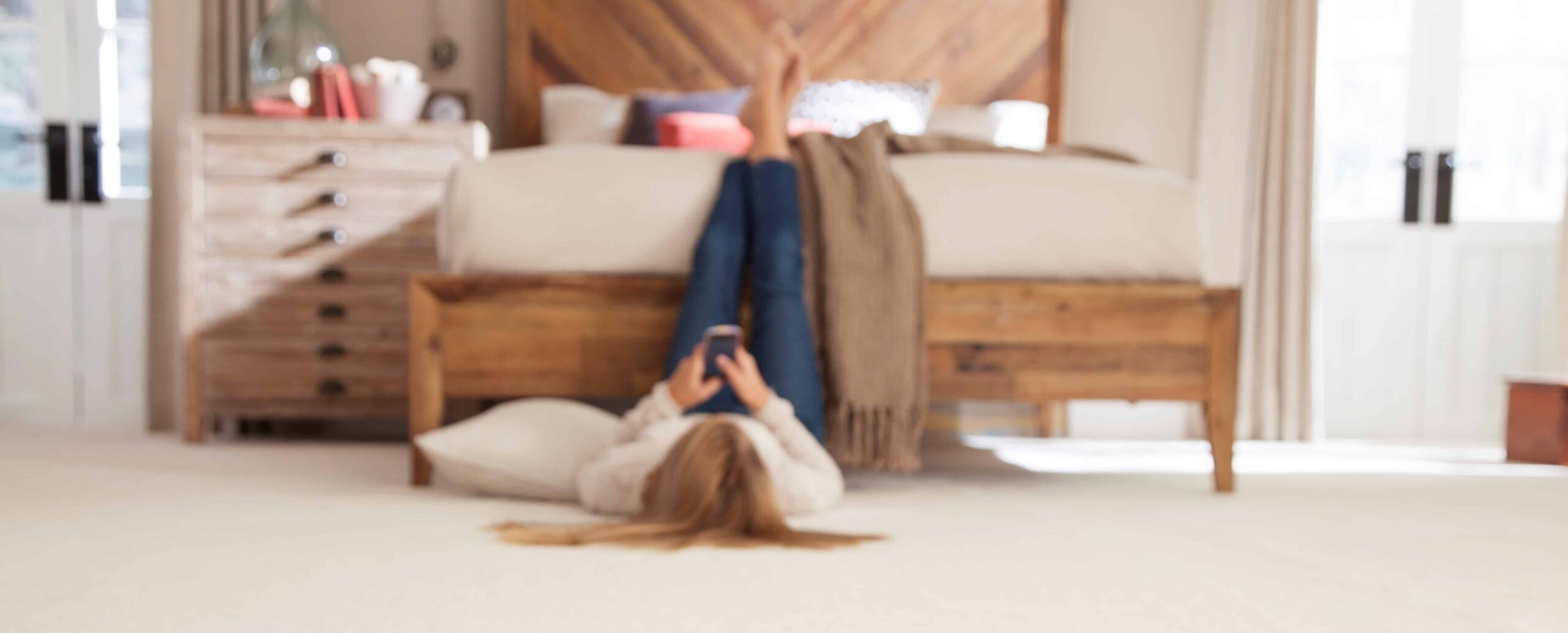 Woman relaxing on phone on carpet